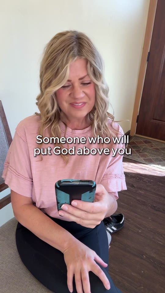 Looking at the phone and smiling